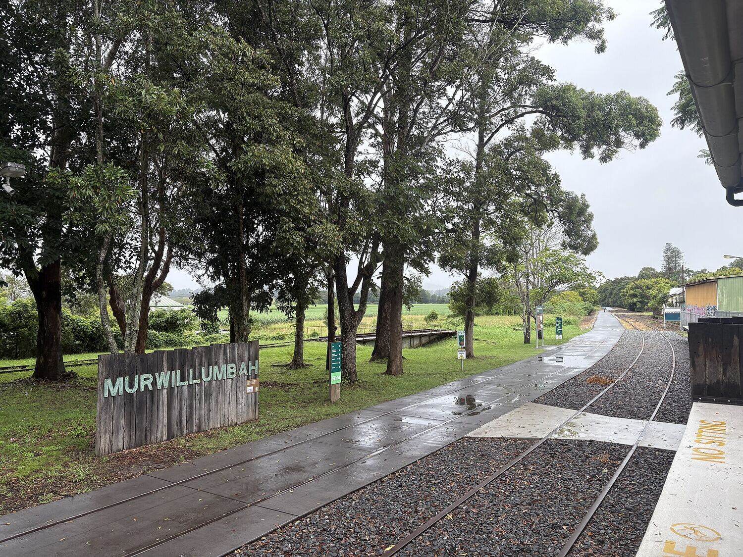The old Murwillumbah railway platform with its station nameboard, where the rail trail starts beside the original tracks